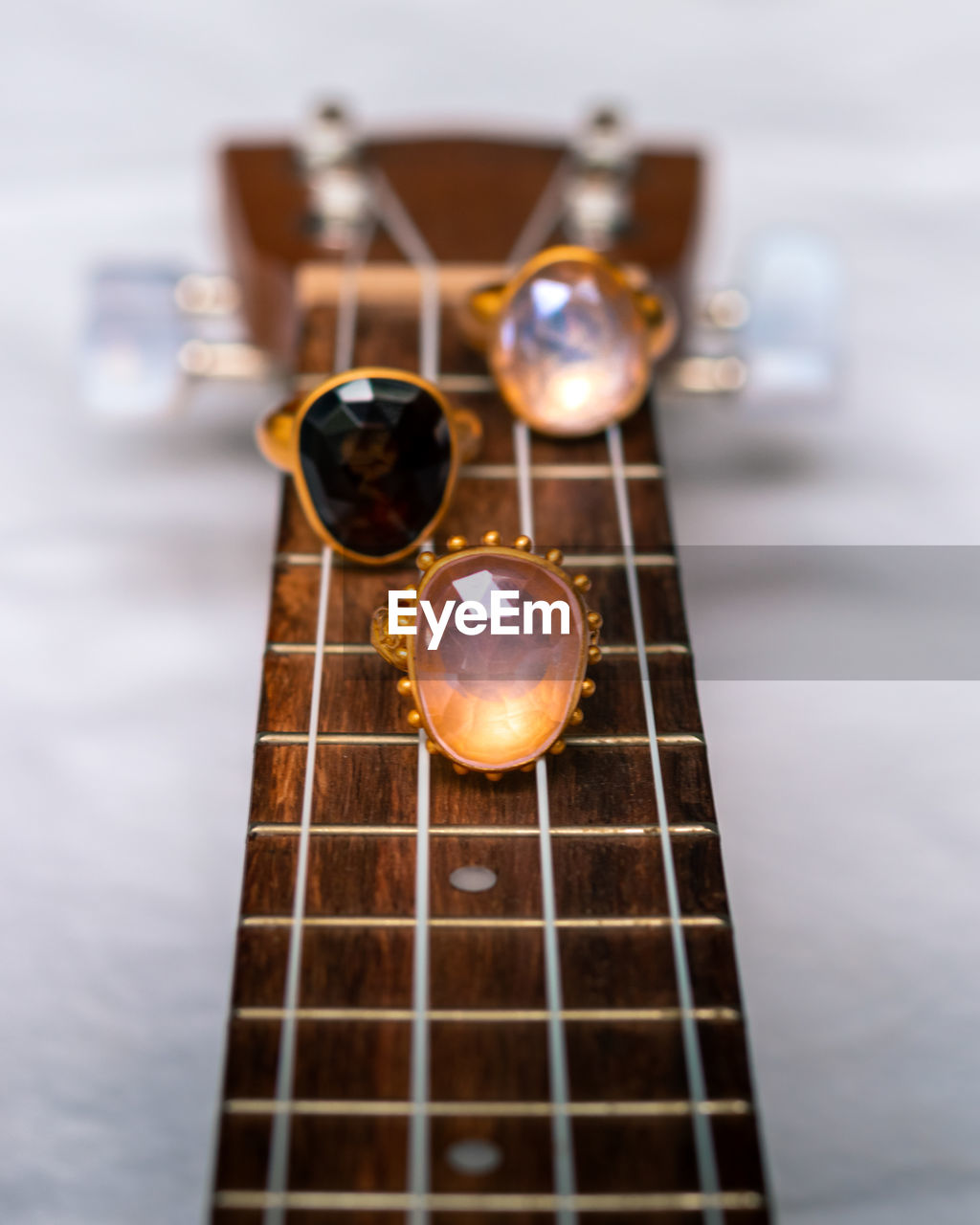 Rings product photo on a ukulele, white background 