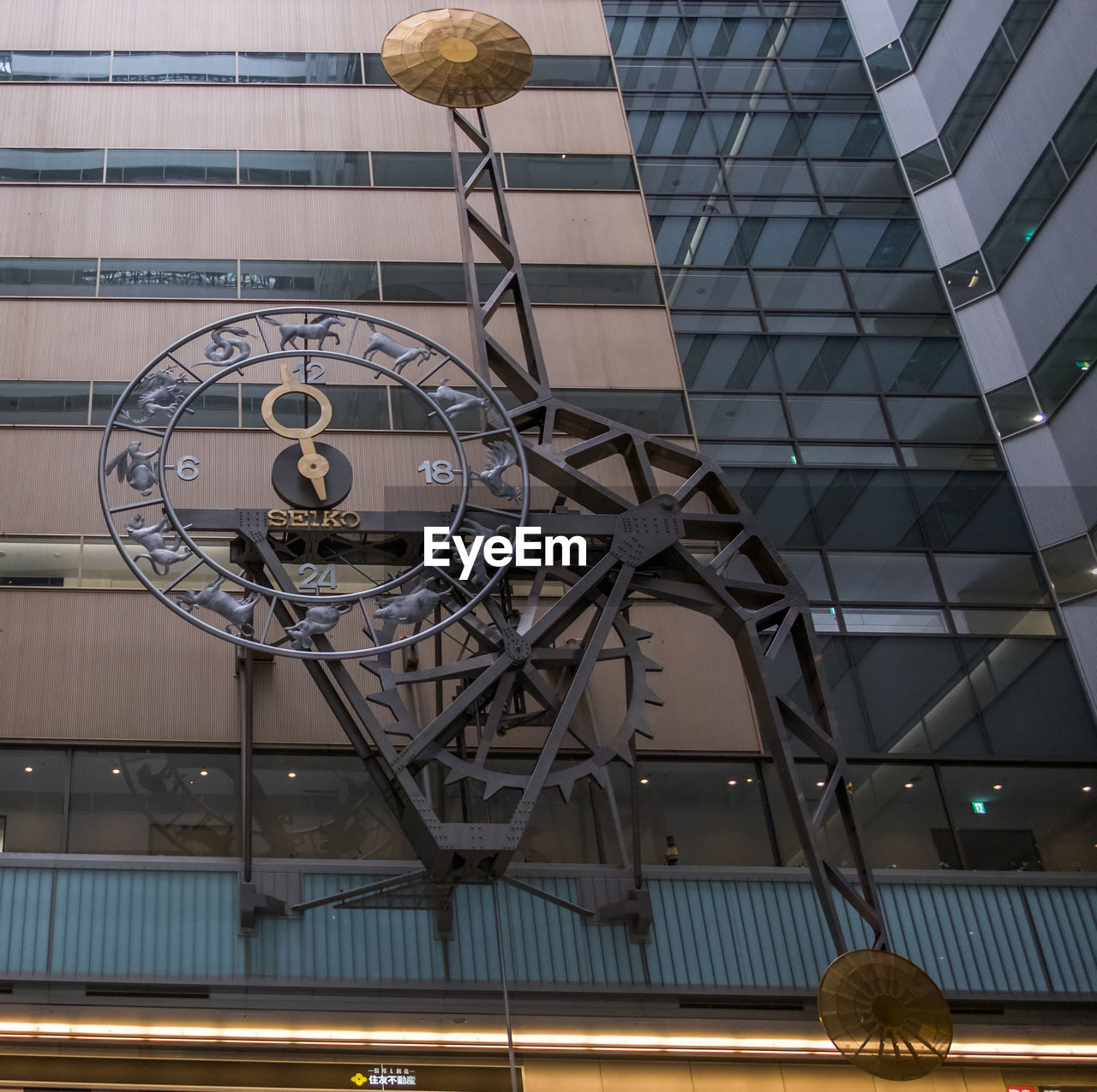 LOW ANGLE VIEW OF CLOCK ON CEILING IN CITY