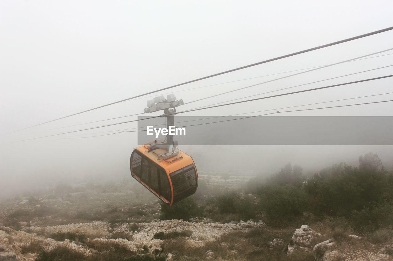 Overhead cable car during foggy weather