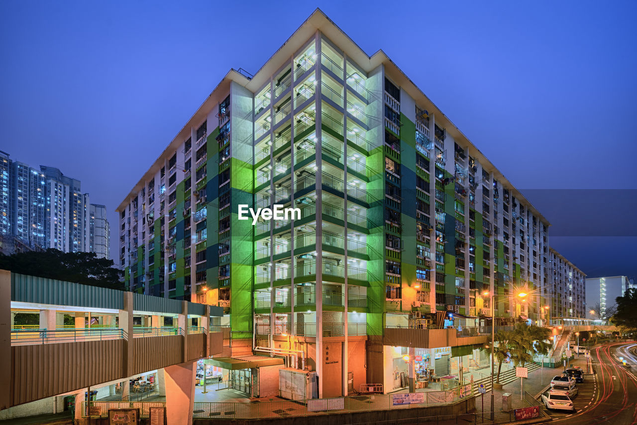 Modern buildings against blue sky at night