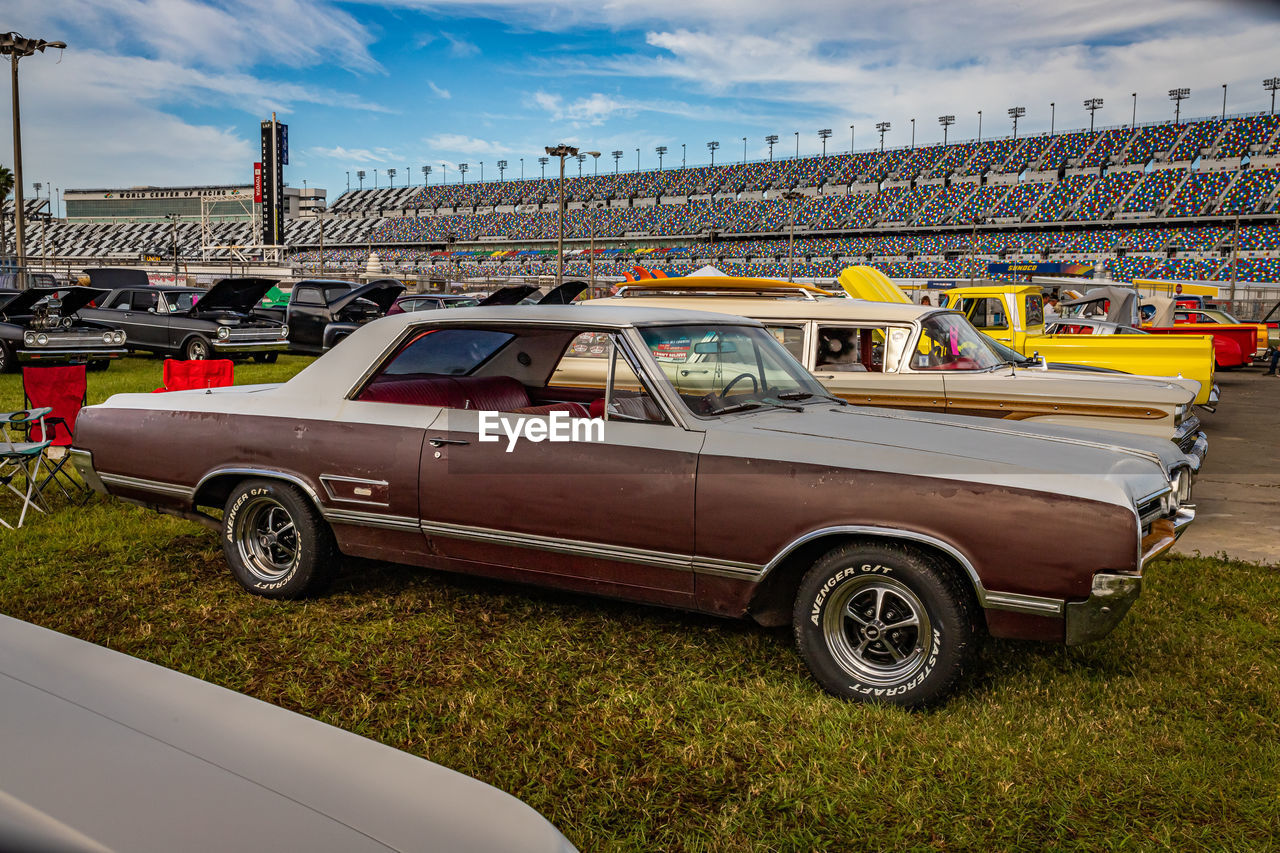 VINTAGE CAR AGAINST CLOUDY SKY