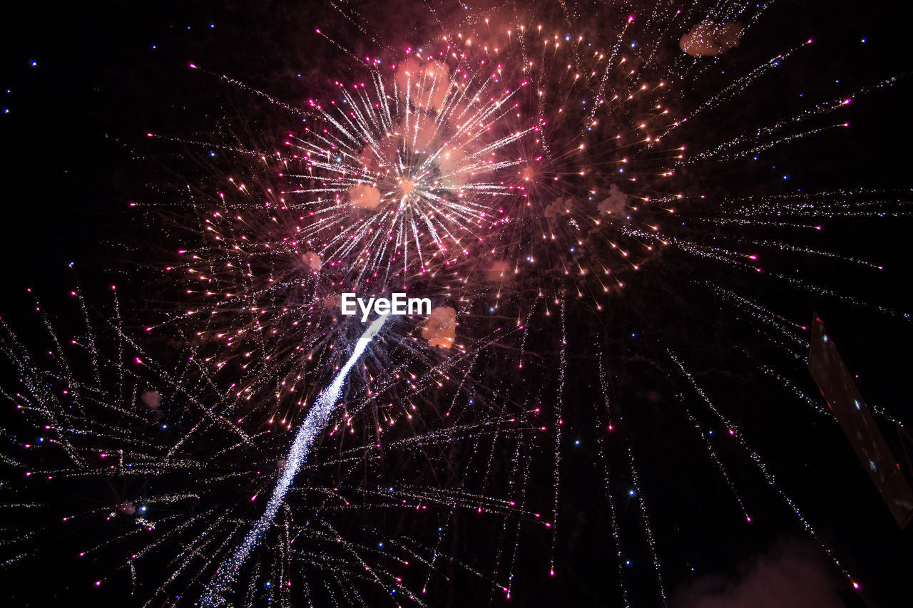 LOW ANGLE VIEW OF FIREWORKS EXPLODING IN SKY