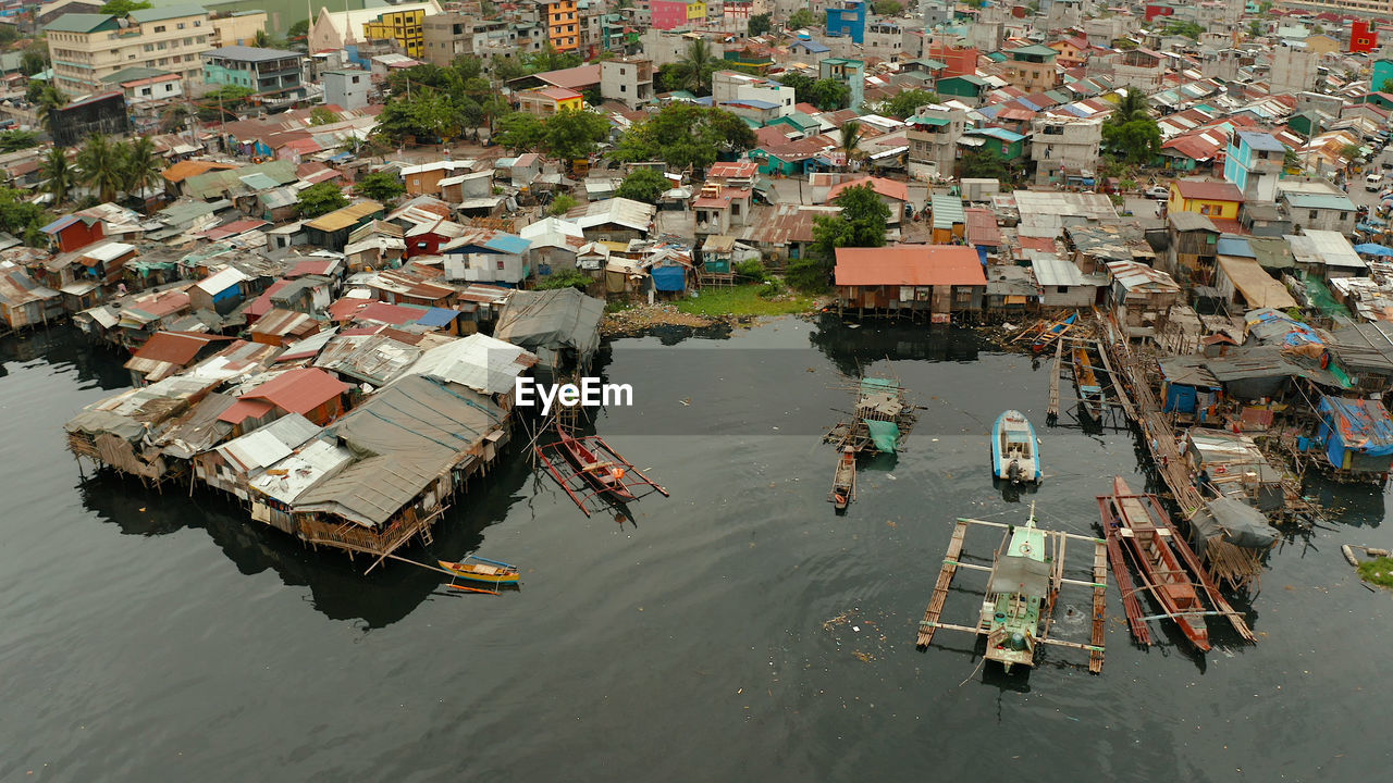 Slum area in manila, phillippines, top view. lot of garbage in the water.