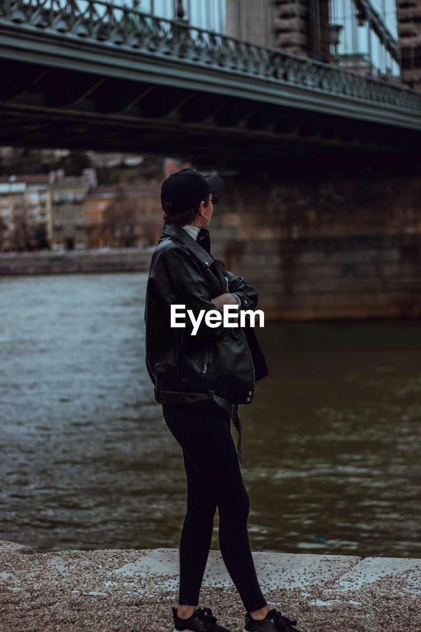 FULL LENGTH OF MAN STANDING BY BRIDGE