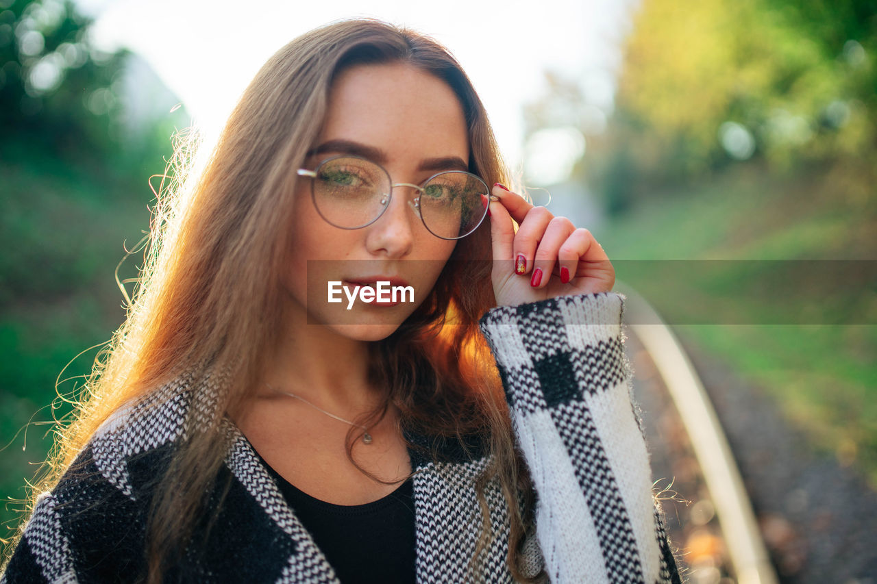 Sunny portrait young woman in glasses