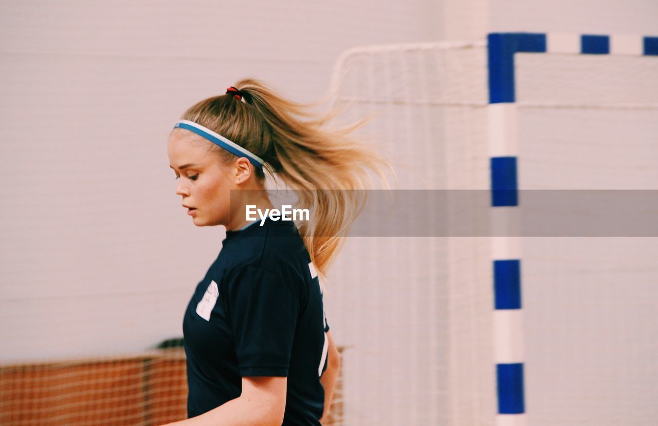 Side view of young woman in sports clothing