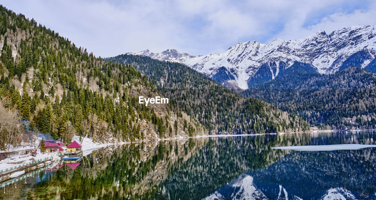 SCENIC VIEW OF LAKE AND SNOWCAPPED MOUNTAINS AGAINST SKY