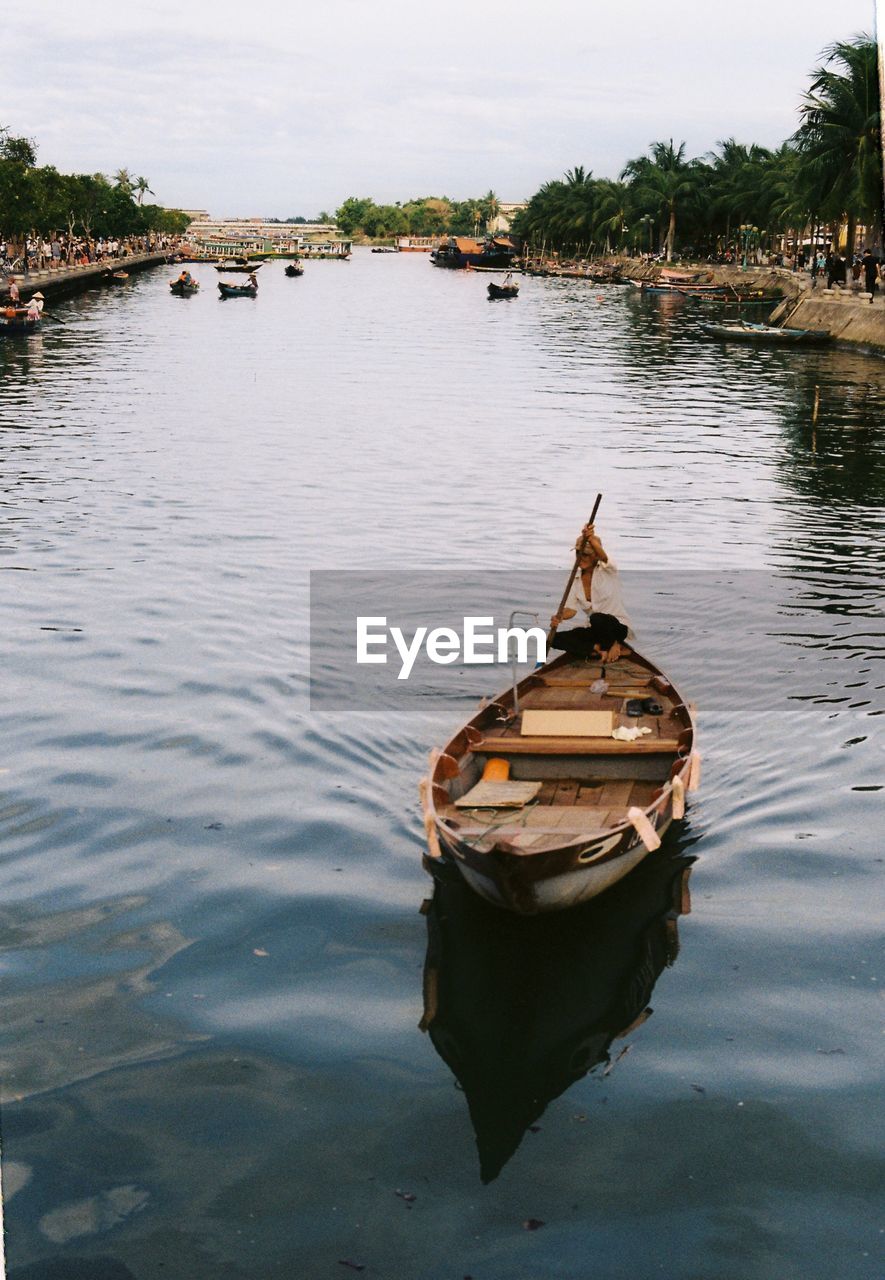 Boat moored in lake against sky