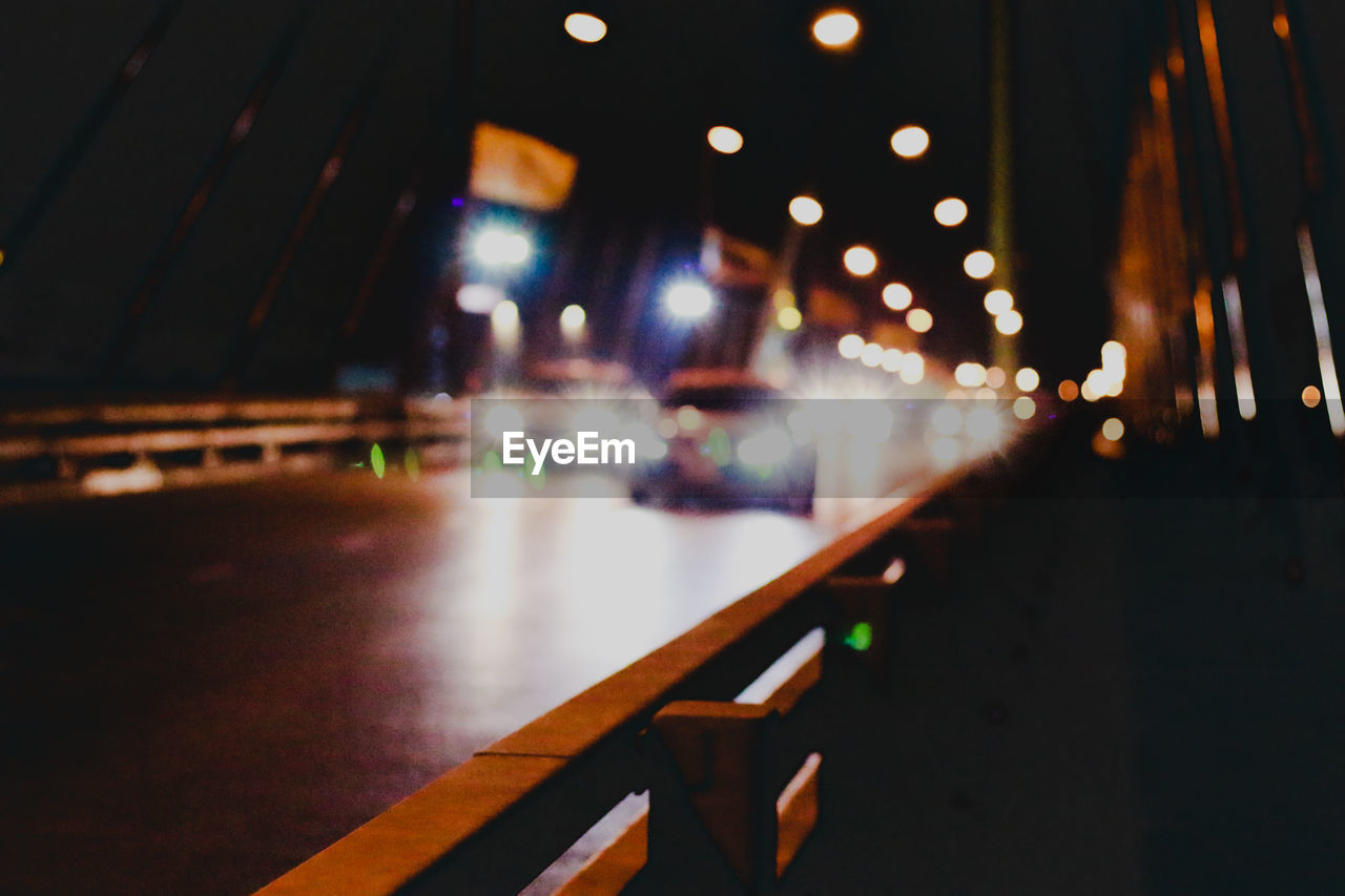 Defocused image of illuminated street at night