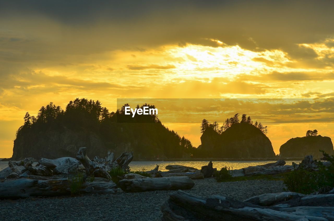 Scenic view of rocks against sky during sunset