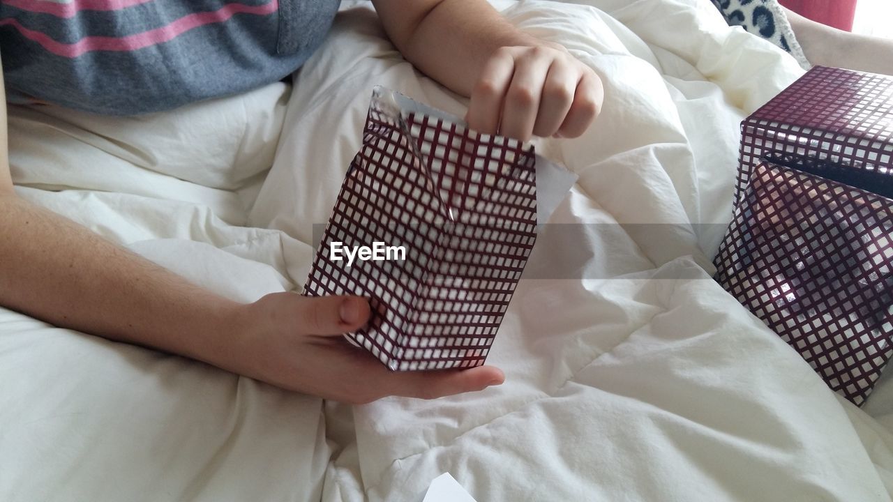 Close-up of woman holding bed