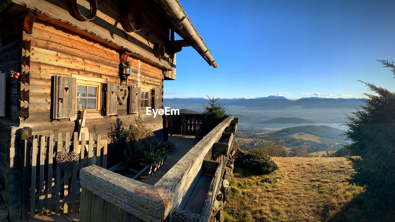 Panoramic view of buildings and mountains against clear blue sky