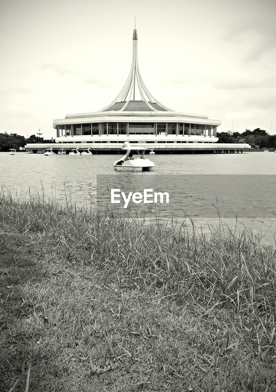 VIEW OF RIVER WITH BUILDINGS IN BACKGROUND