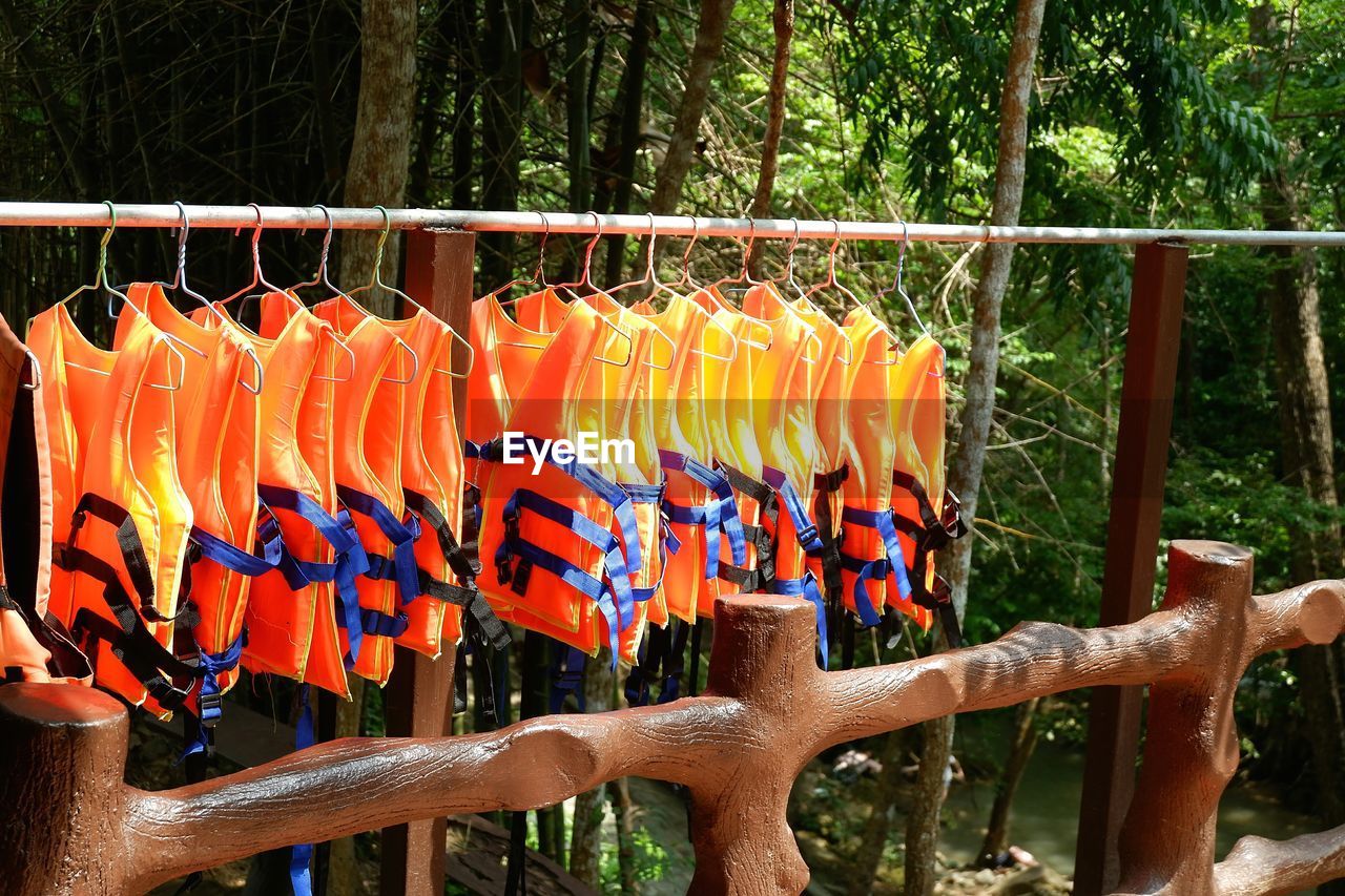 VARIOUS FLAGS HANGING ON FENCE