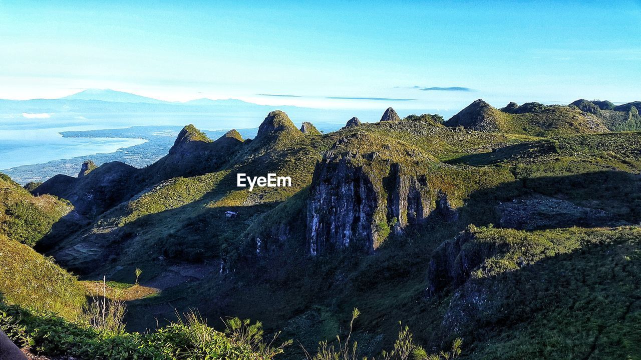 Panoramic view of rocks and sea against sky