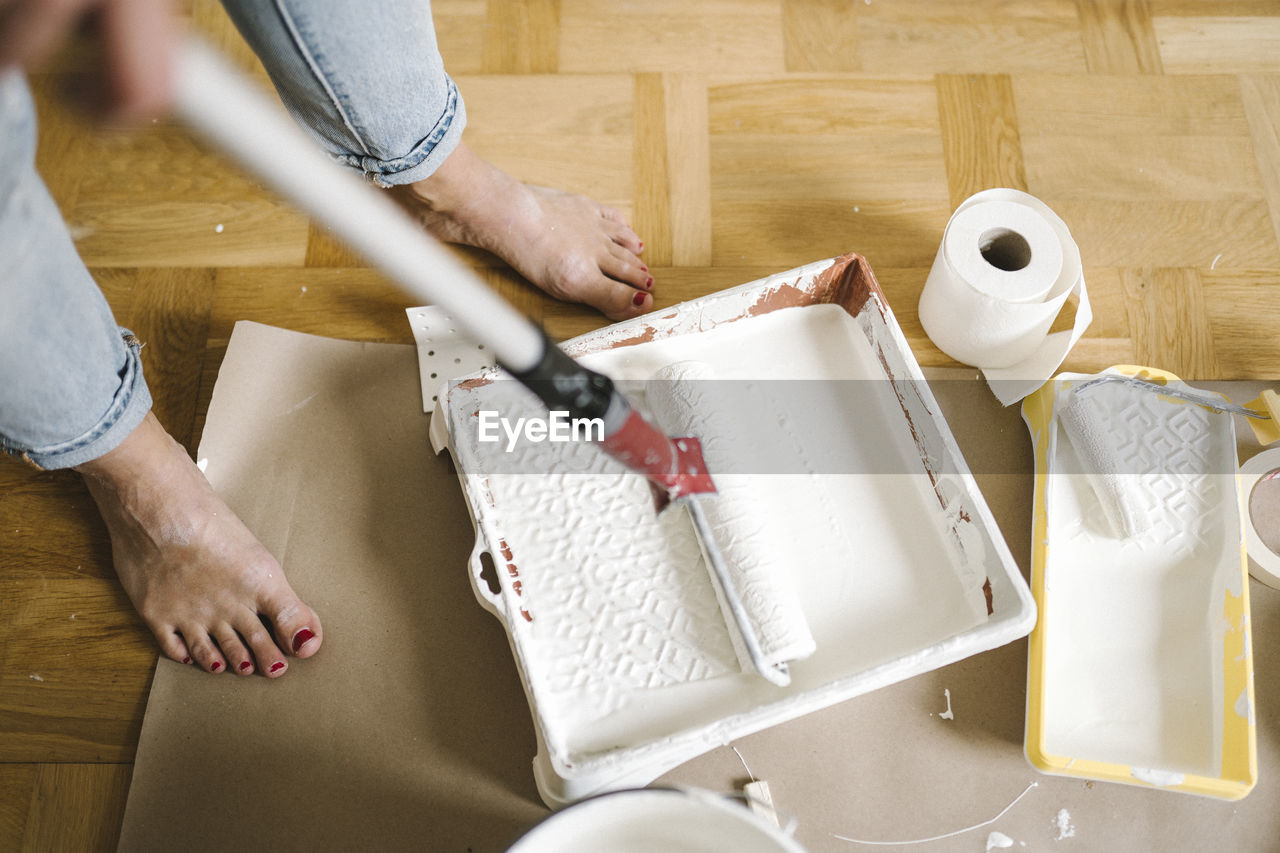 Woman painting room barefoot