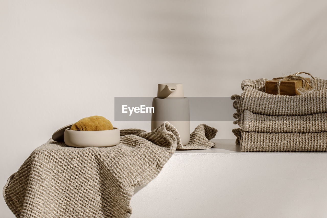 Close-up of coffee cup on table against wall at home