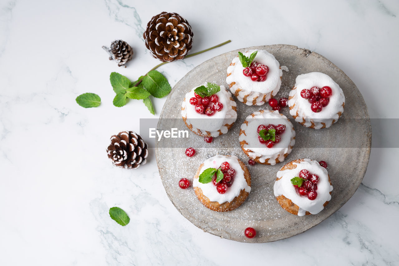 High angle view of christmas muffins with pine cones on table