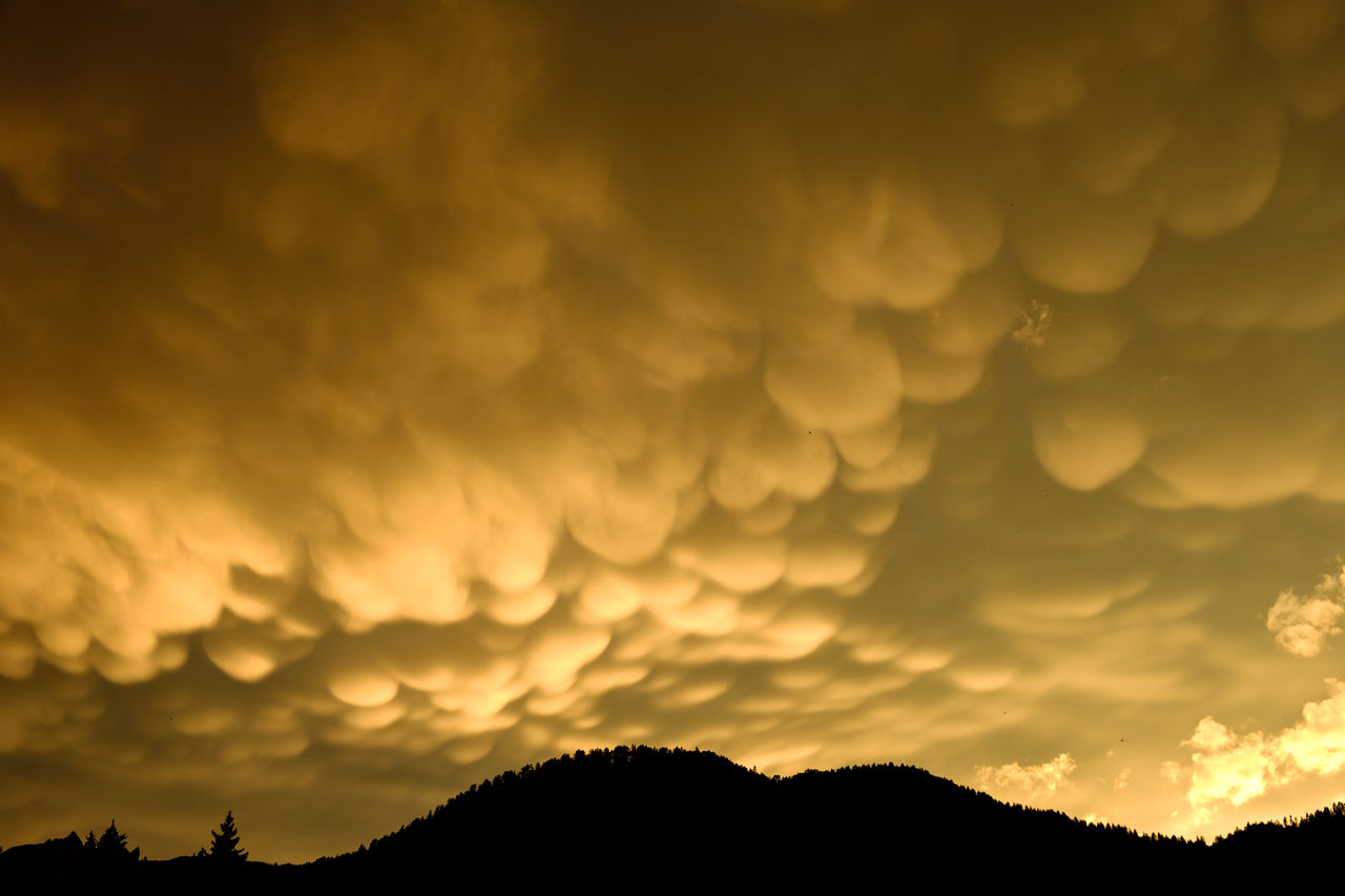 Low angle view of silhouette mountains against sky during sunset