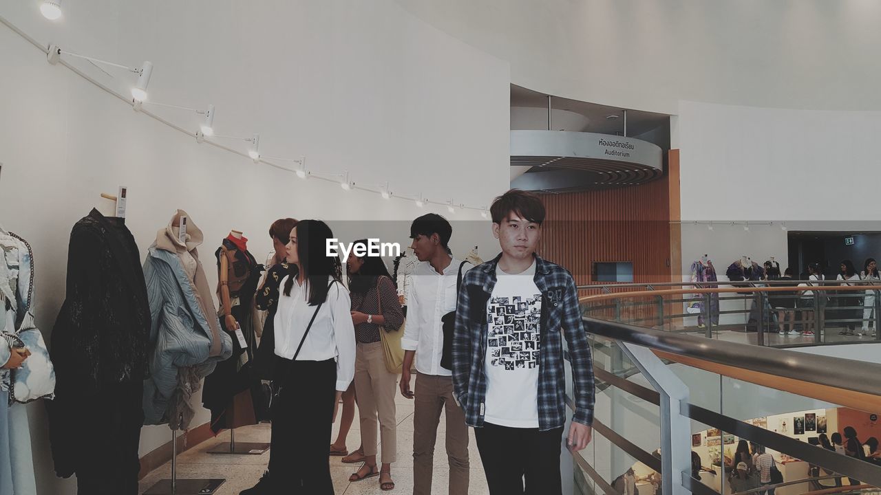 GROUP OF PEOPLE STANDING IN STORE