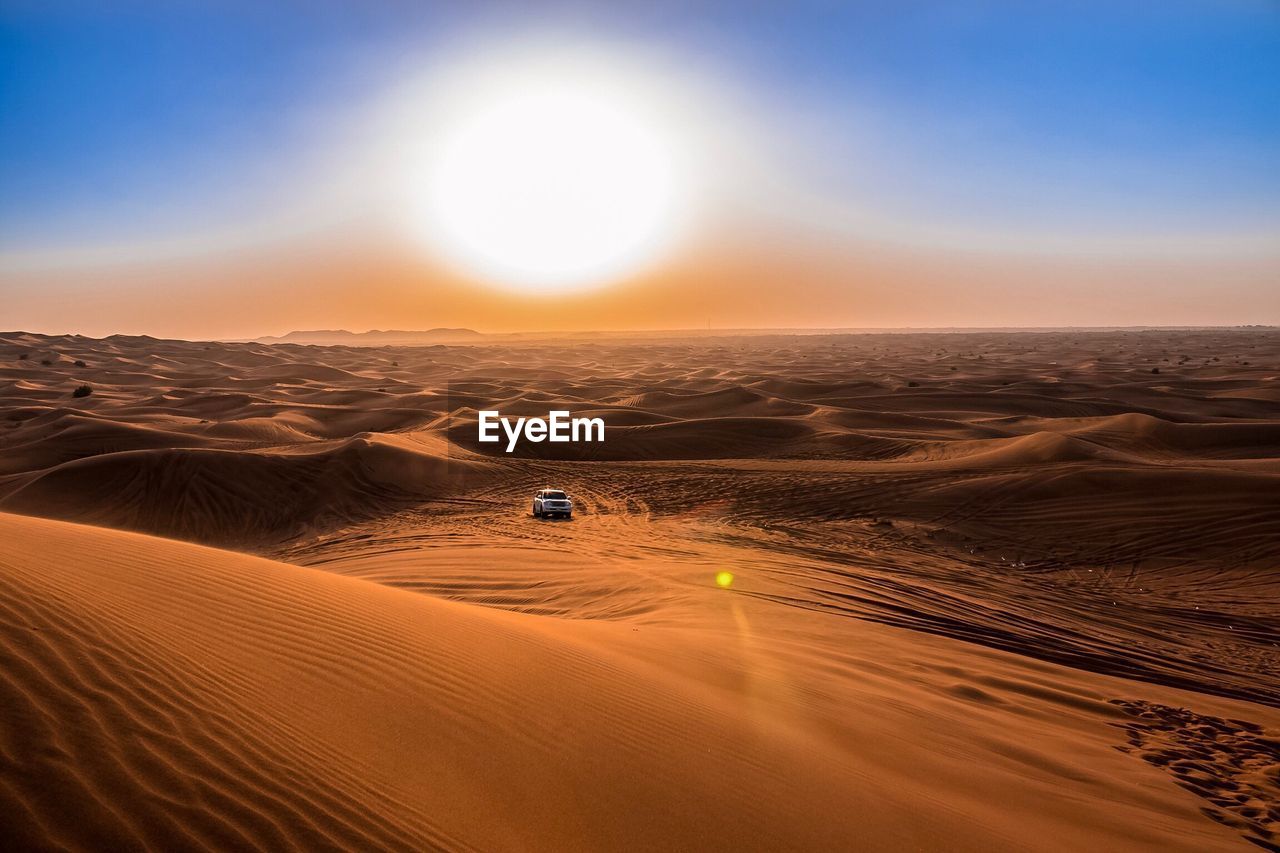 Scenic view of desert against sky during sunset