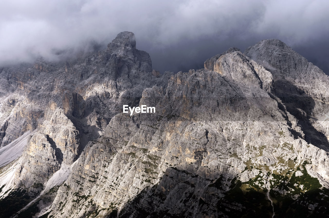 Rocky mountains against clouds