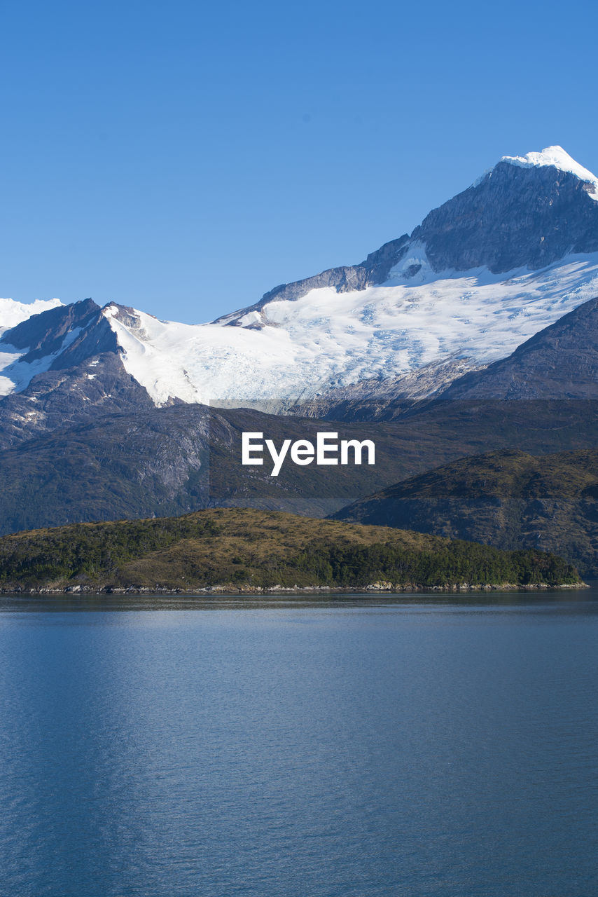 SCENIC VIEW OF SNOWCAPPED MOUNTAINS AGAINST BLUE SKY