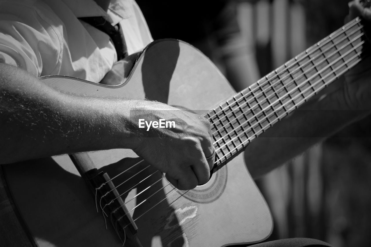 Close-up of man playing guitar