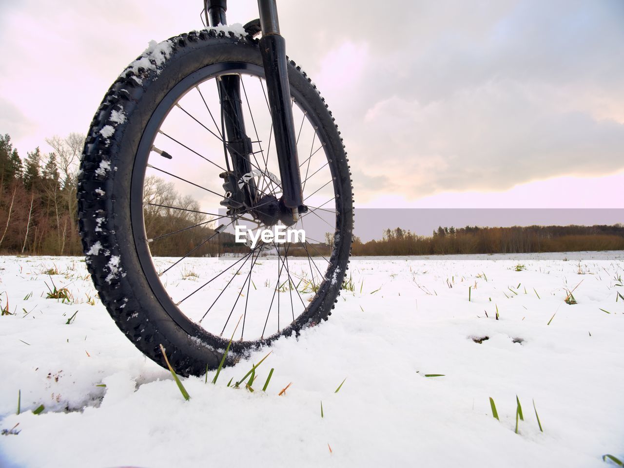 Cyclist on mountain bike on snowy hill. landscape with fresh snow. extreme sports and biking concept