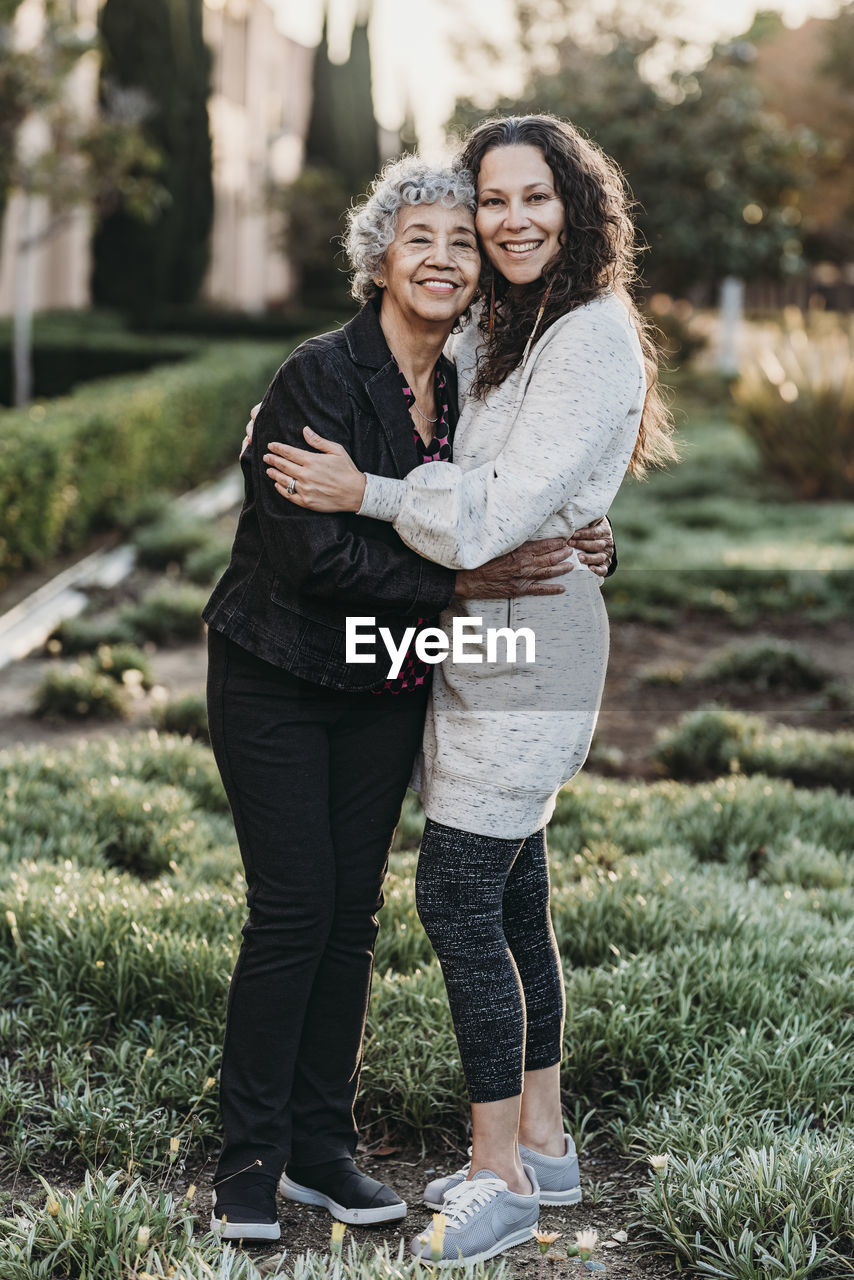 Portrait of active senior grandmother and adult daughter smiling