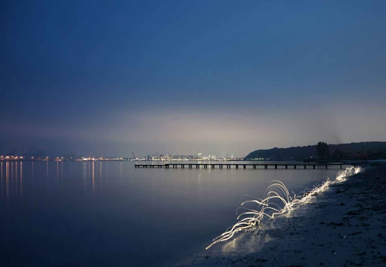 Scenic view of sea against clear sky at sunset