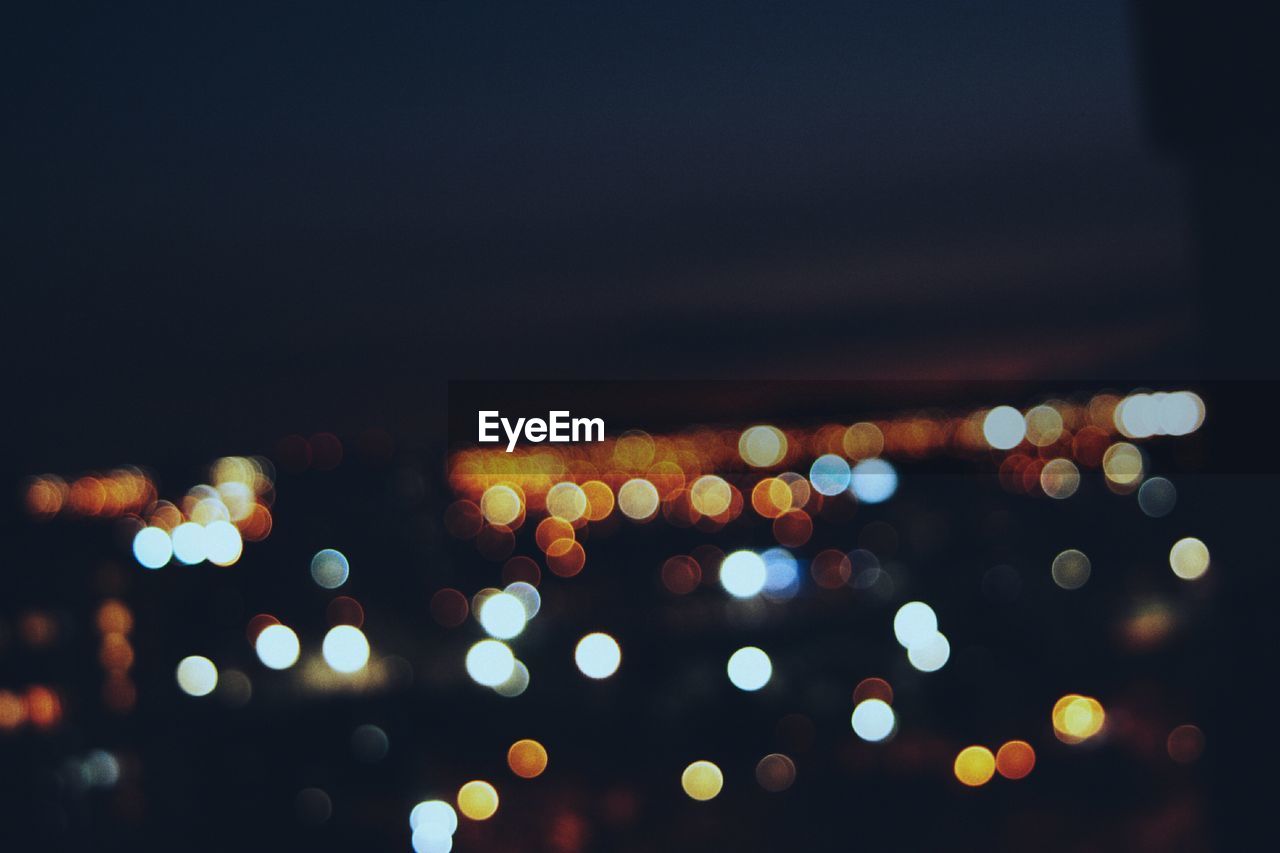 Defocused image of illuminated city at night