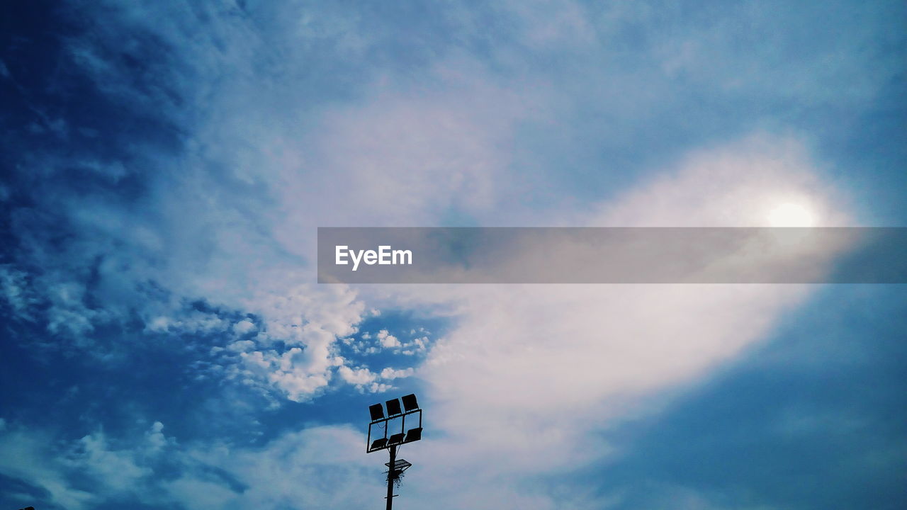 Low angle view of floodlight against sky