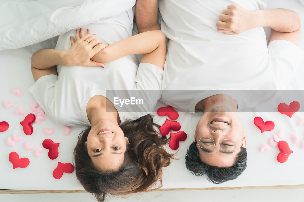 Directly above shot of couple relaxing on bed at home