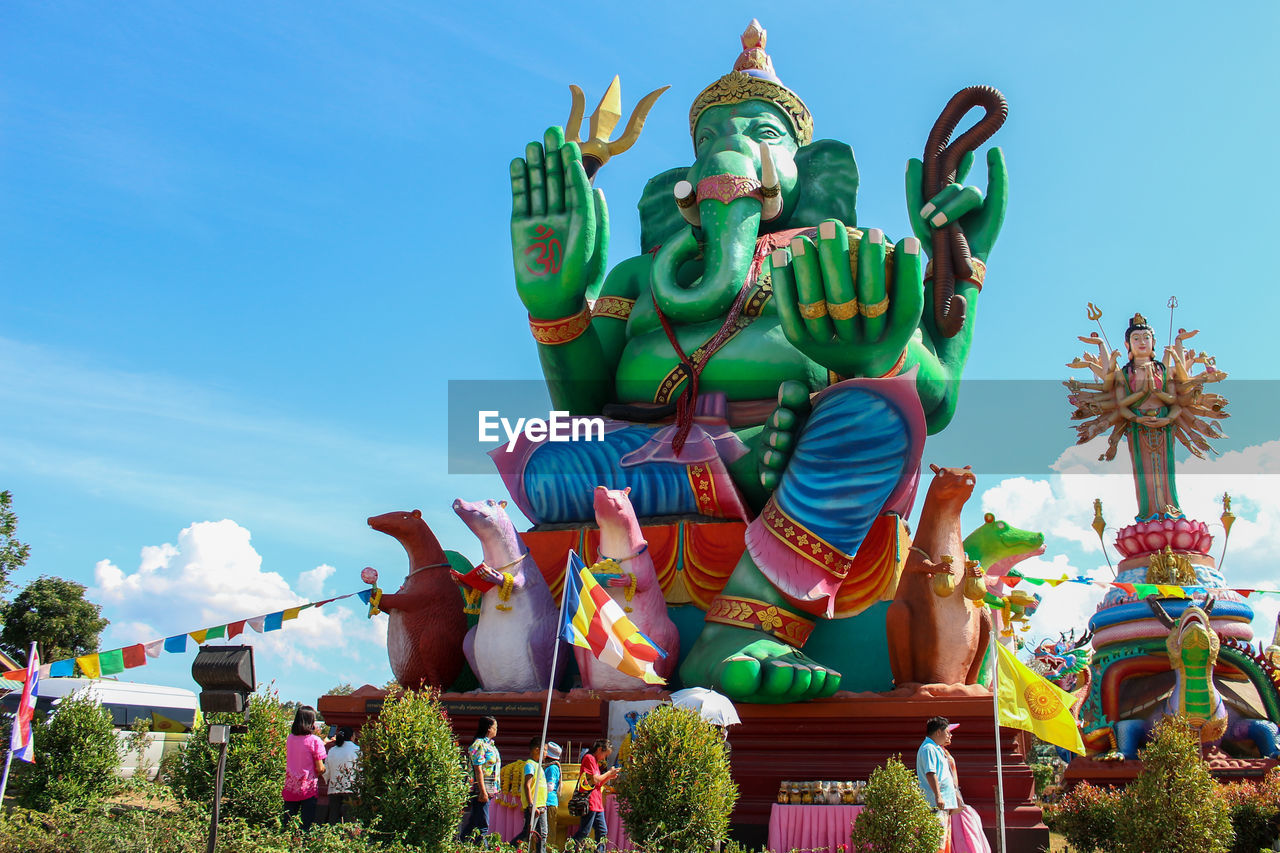 Low angle view of religious statues against sky