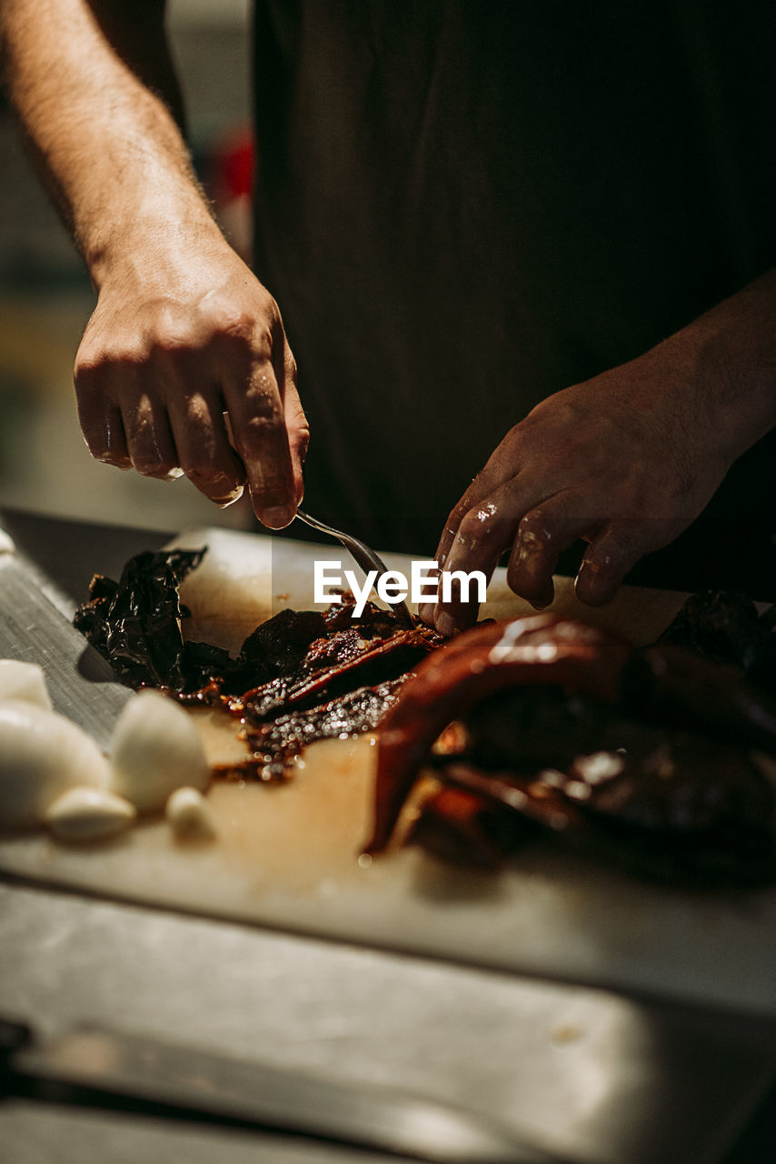 Midsection of man preparing food