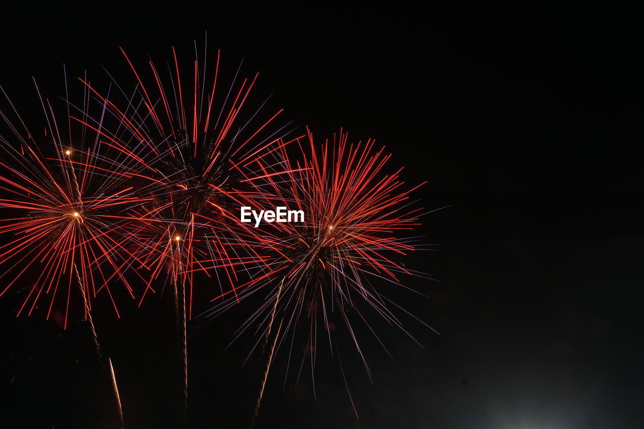 LOW ANGLE VIEW OF FIREWORK DISPLAY IN SKY AT NIGHT