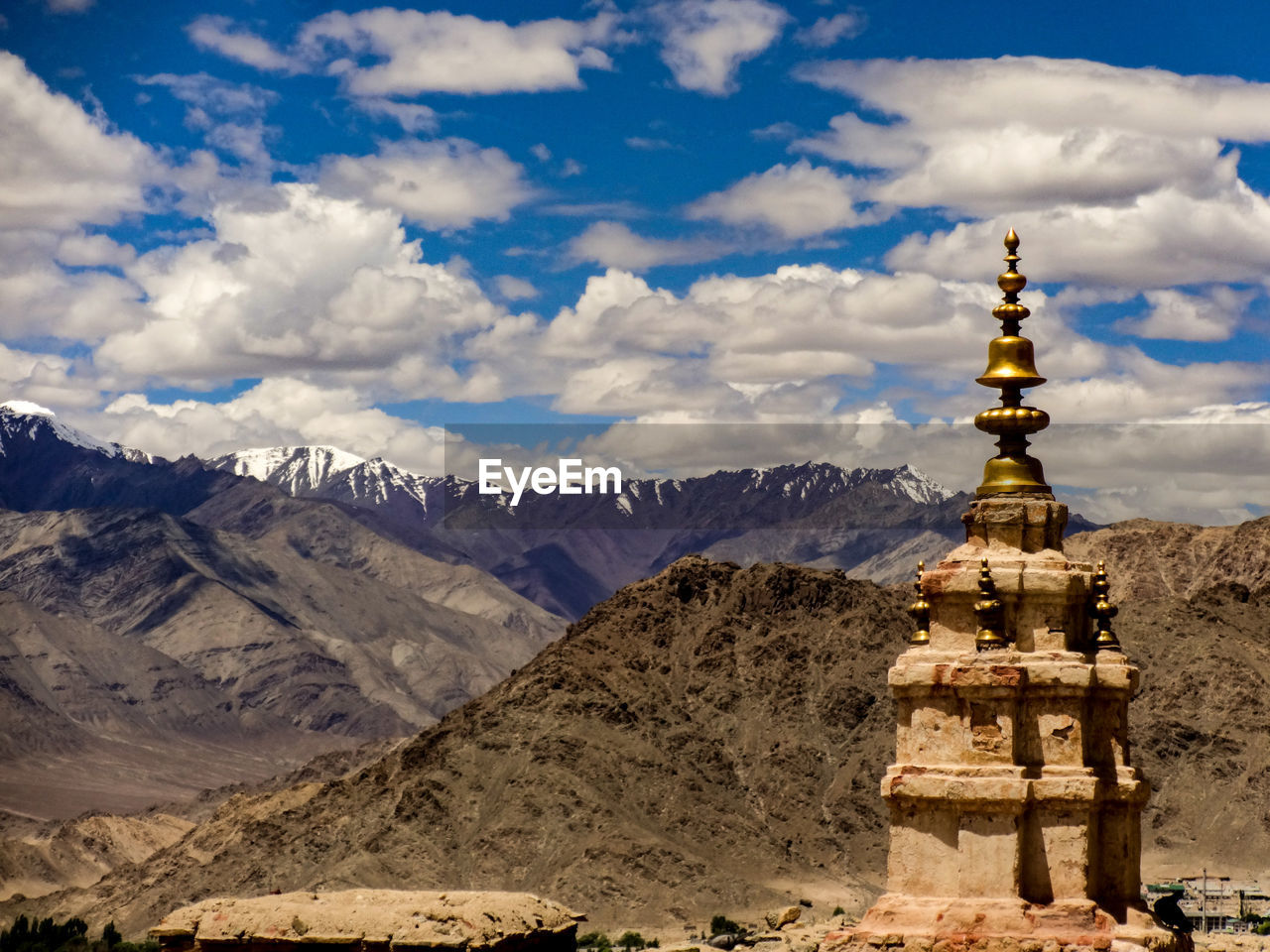 View of tibetan buddhist temple against cloudy sky