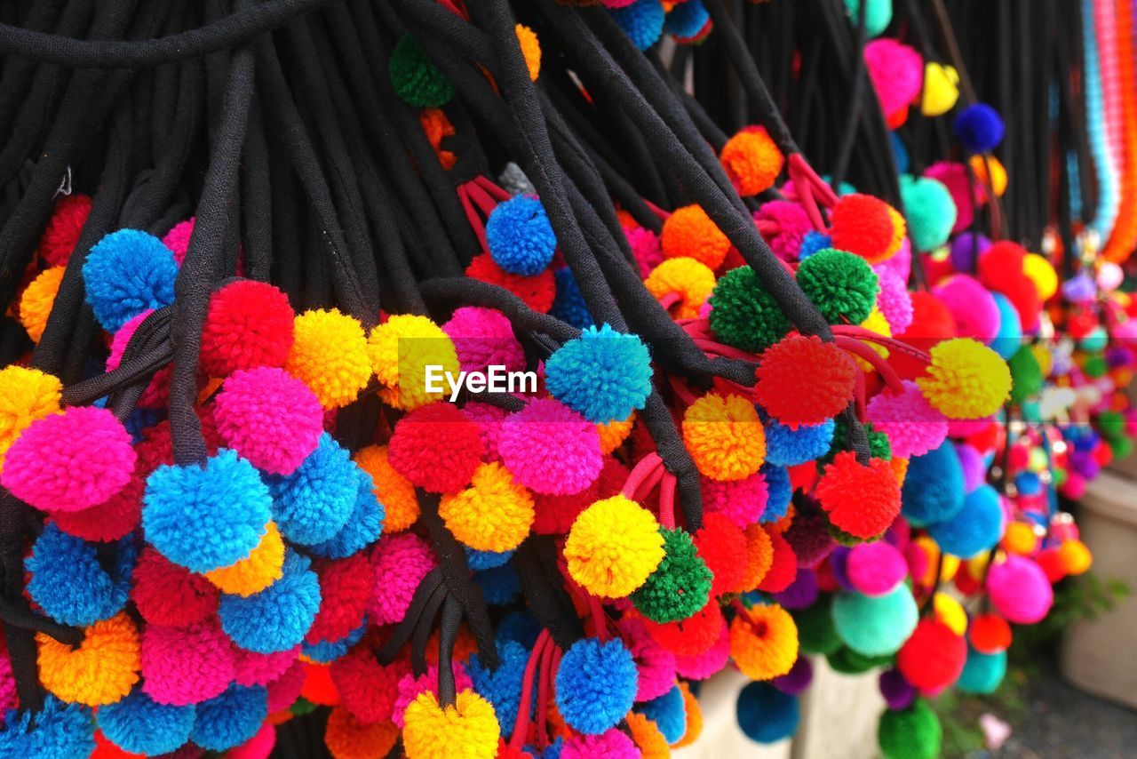 Close-up of colorful woolen decorations for sale at market stall