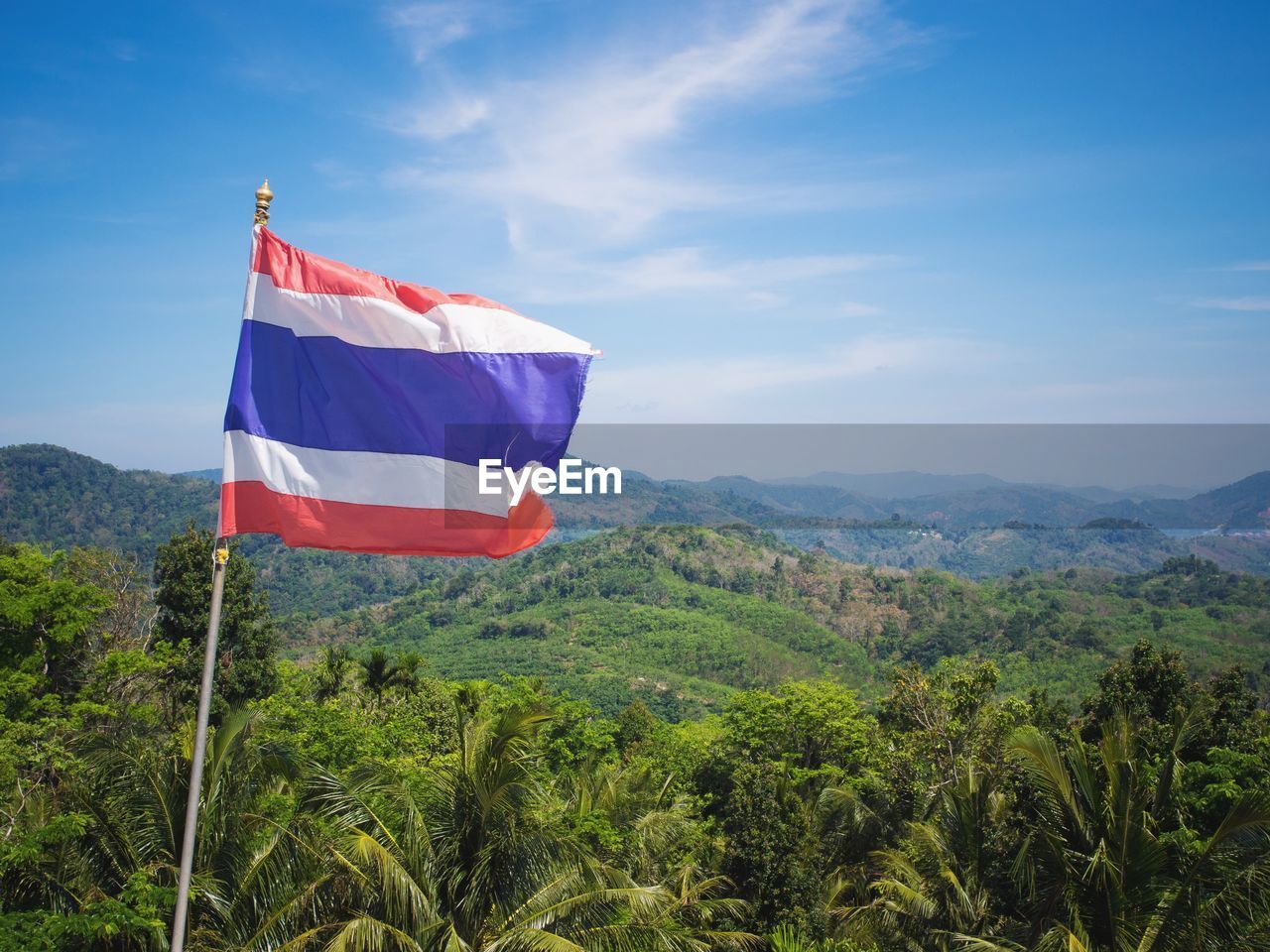 Flag of thailand with view on phuket