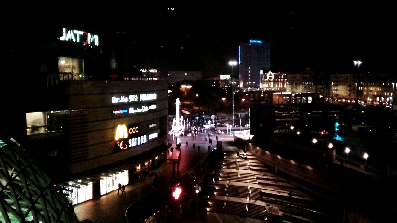 ILLUMINATED CITYSCAPE AGAINST SKY