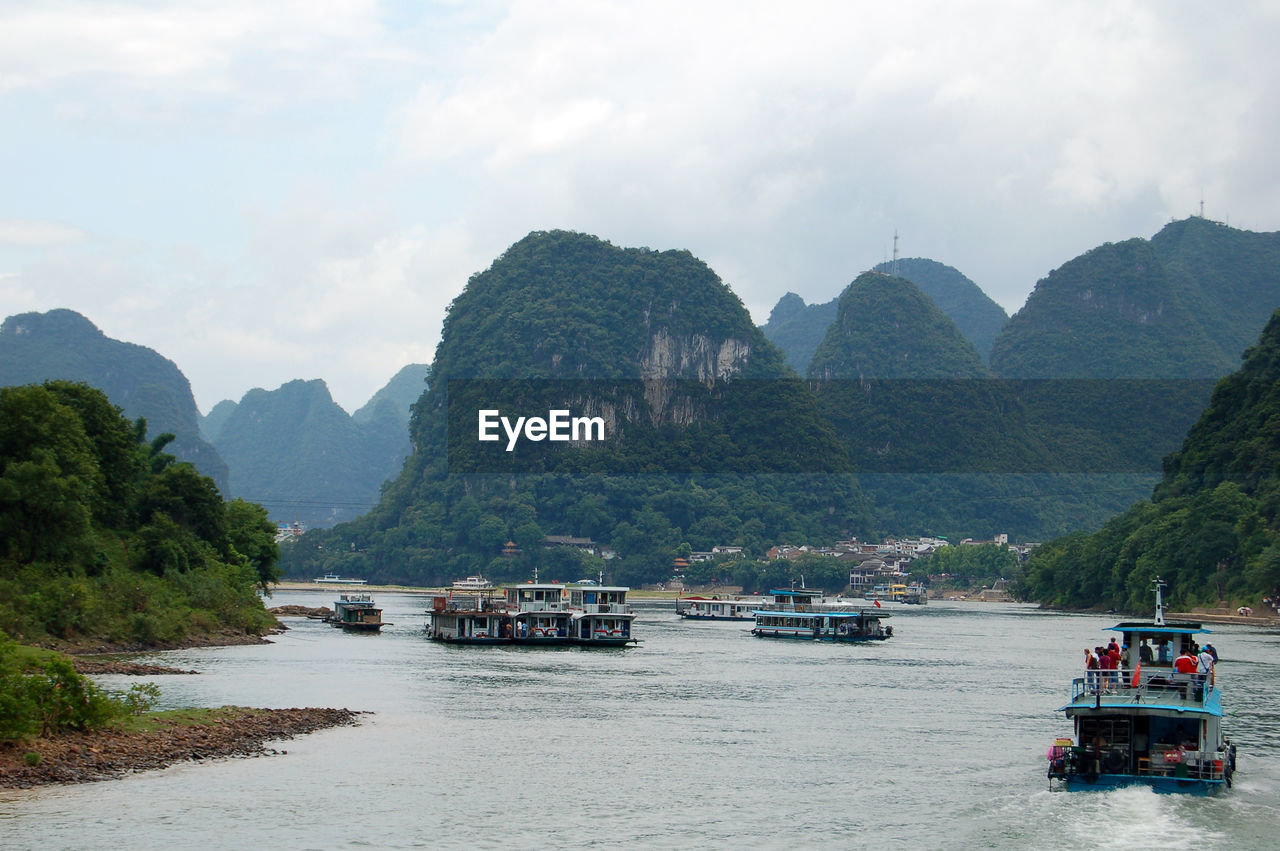 Scenic view of sea and mountains against sky