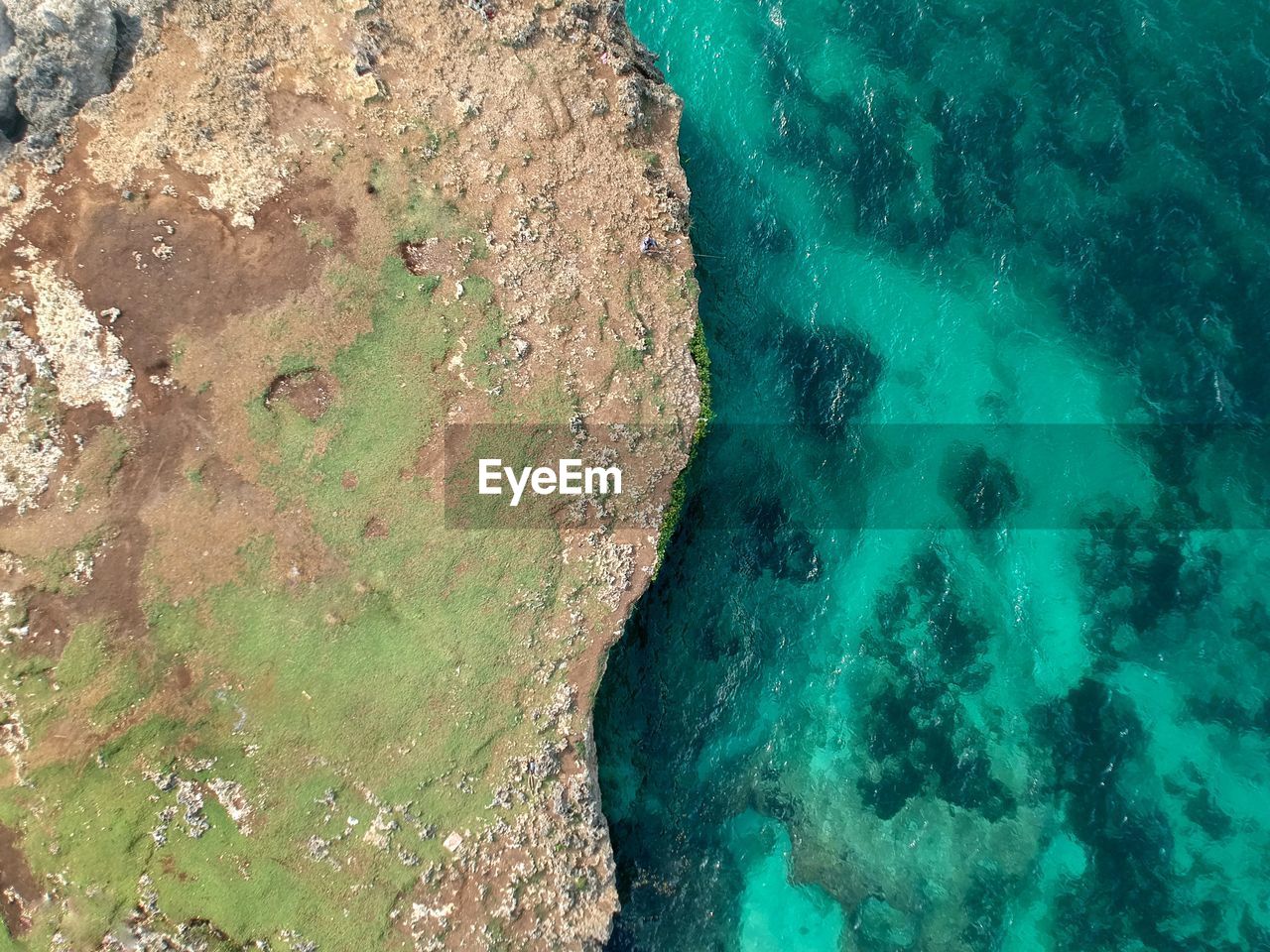 High angle view of rocks on sea shore