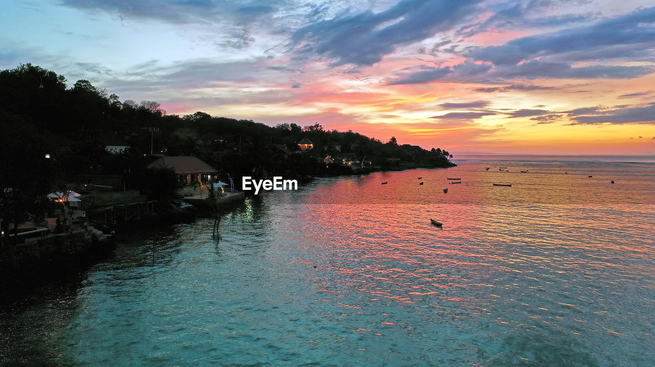 SCENIC VIEW OF SEA AGAINST ORANGE SKY DURING SUNSET