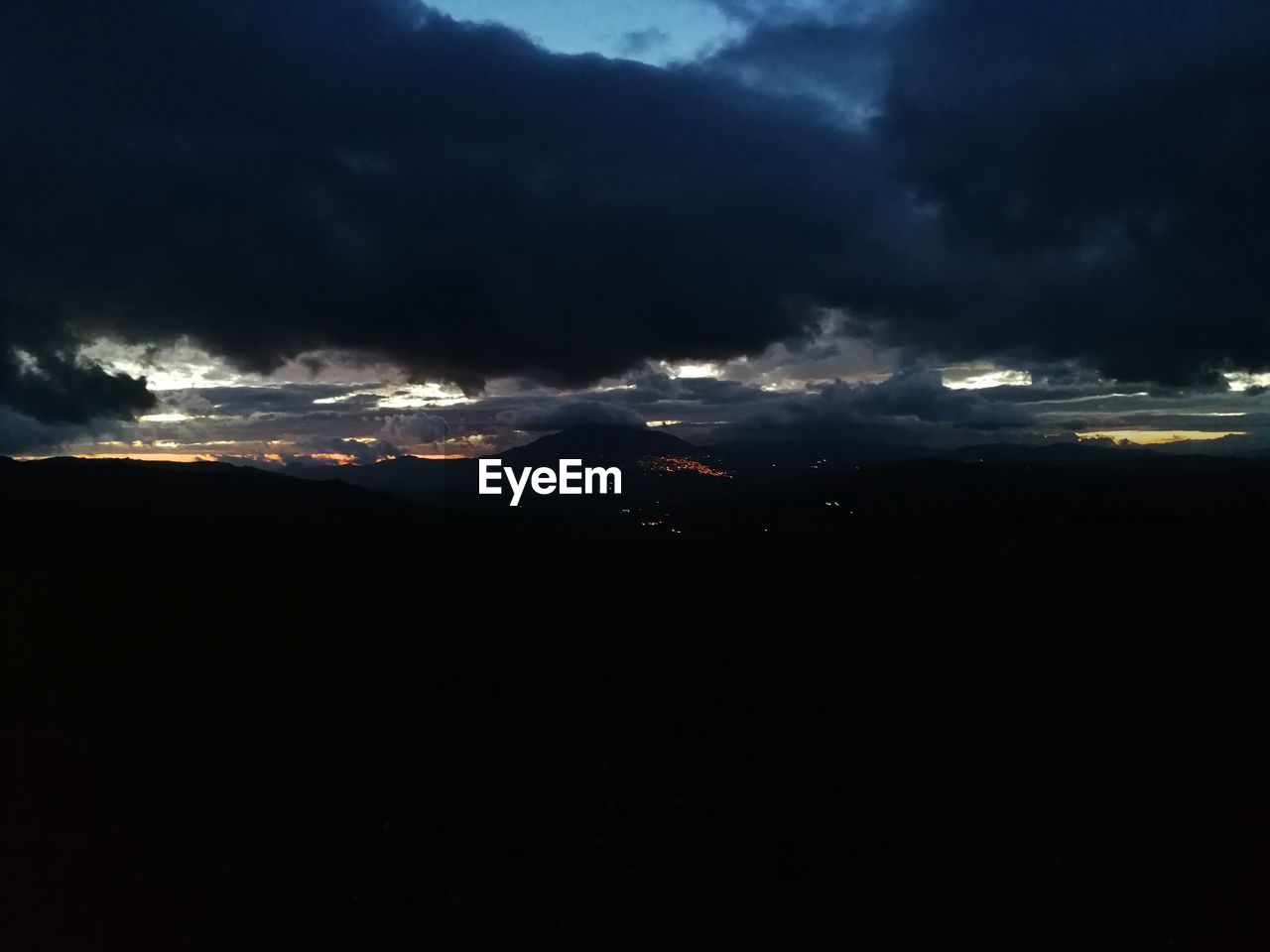 AERIAL VIEW OF STORM CLOUDS OVER SILHOUETTE LANDSCAPE