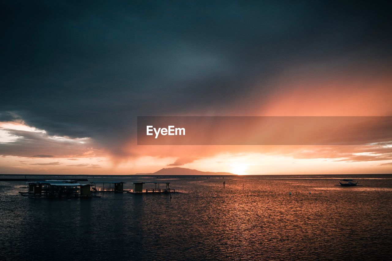 Scenic view of sea against dramatic sky