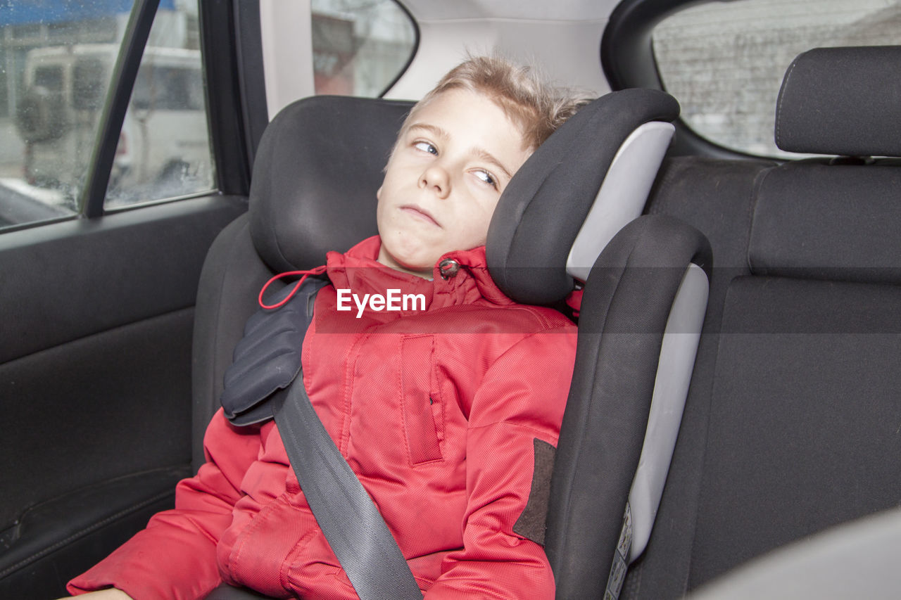 Boy sitting in car