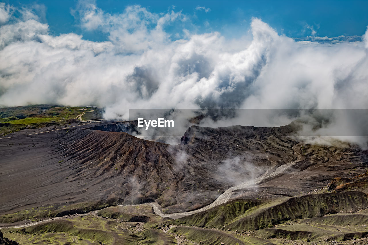 Scenic view on volcanic landscape, clouds in aso crater, aso town in kyushu, japan