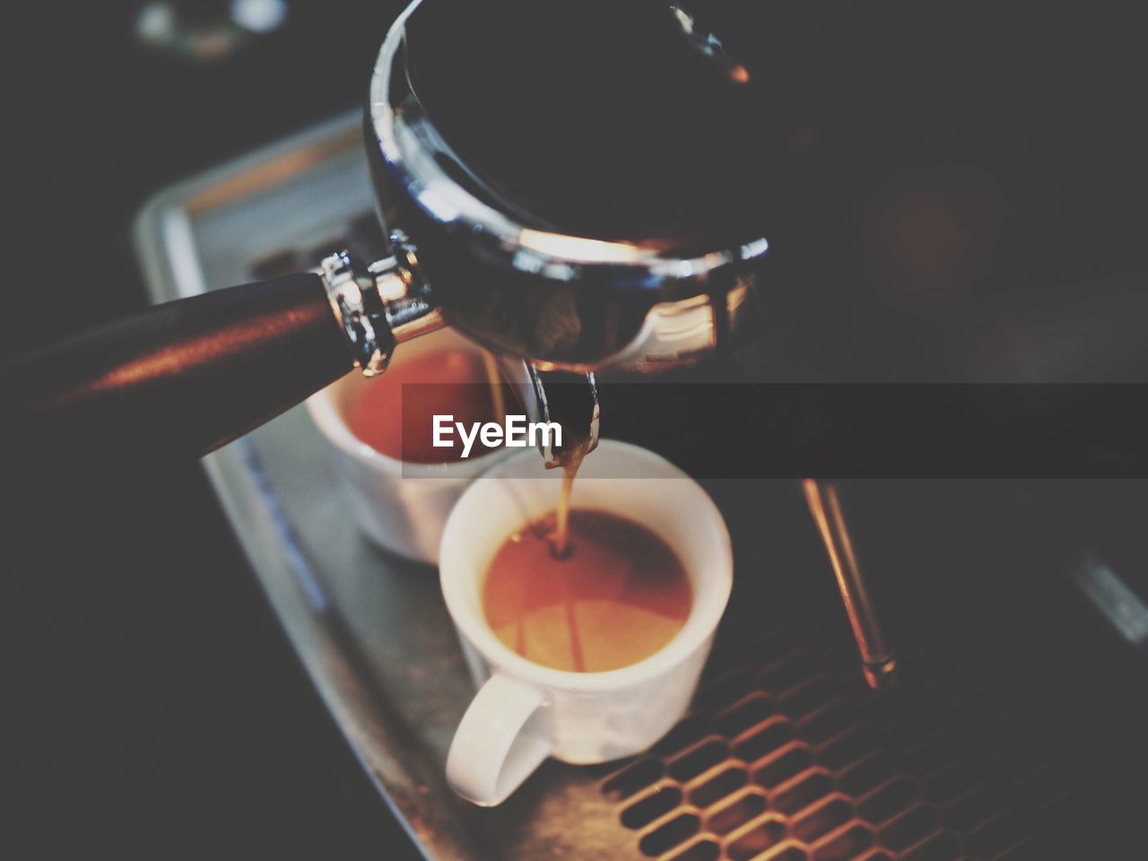 Espresso machine pouring coffee in cups