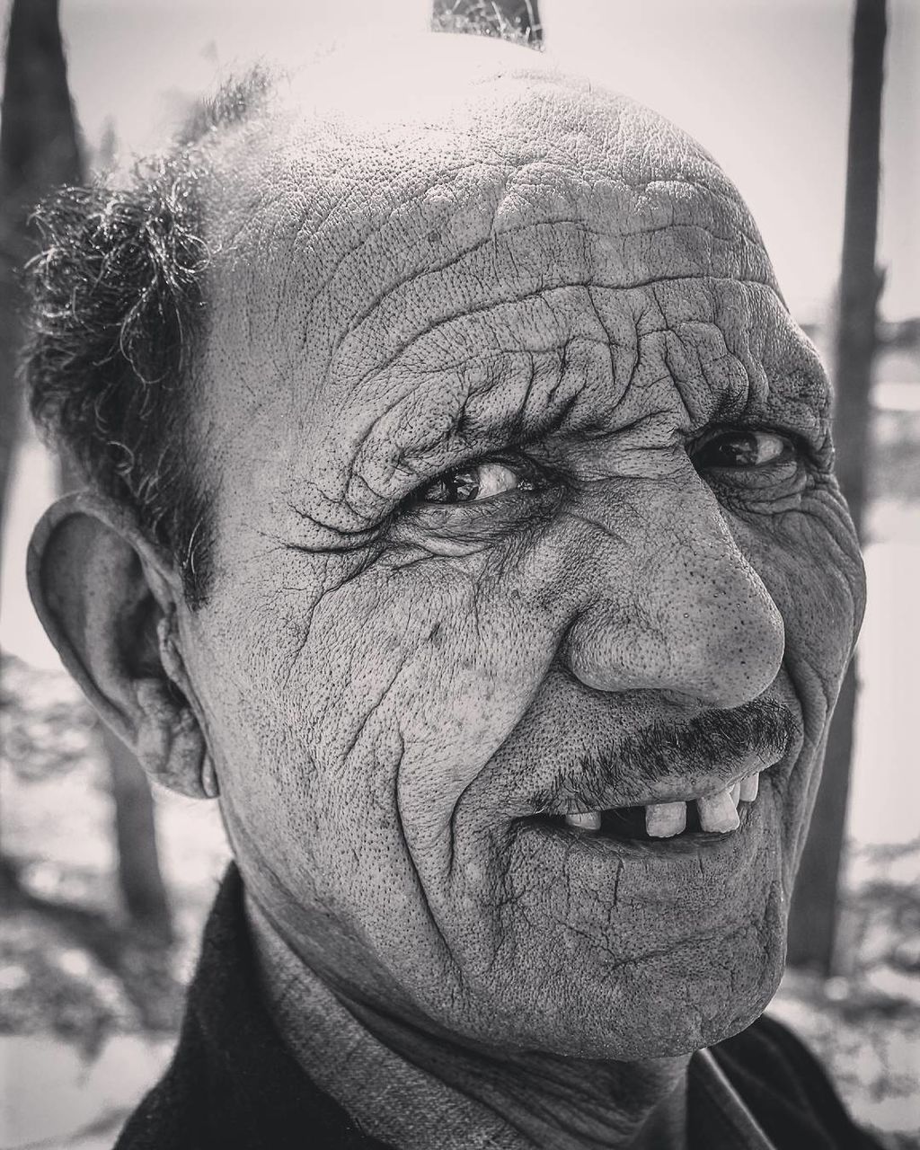 Close-up portrait of senior man outdoors